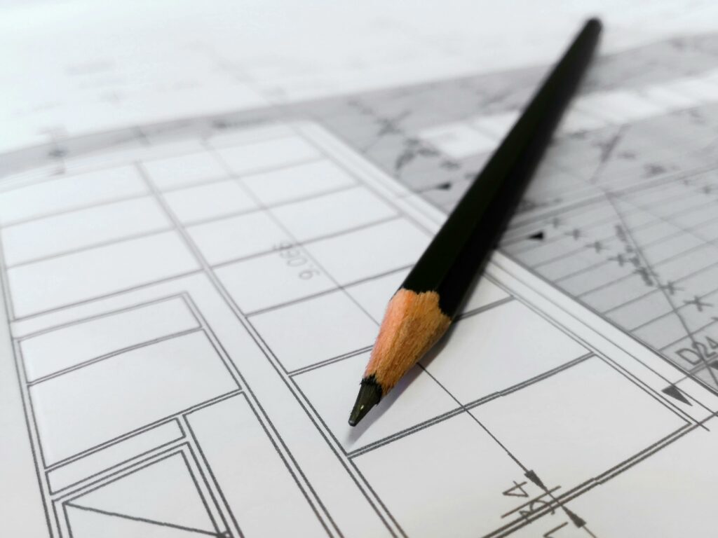 pexels-photo-268362-268362 Detailed image of a black pencil resting on architectural blueprints, ideal for design and planning themes.